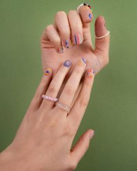 close-up-beautiful-manicure-green-background