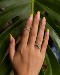 woman-showing-her-nail-art-fingernails-against-monster-leaf (1)