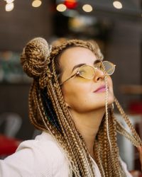 young-beautiful-multiracial-woman-with-blonde-afro-hairstyle-braids-zizi-street-cafe-yellow-sunglasses-bright-makeup-hippie-style